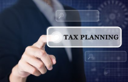 Businessman pressing a TAX PLANNING concept button. Can be used in advertising. Tax Planning